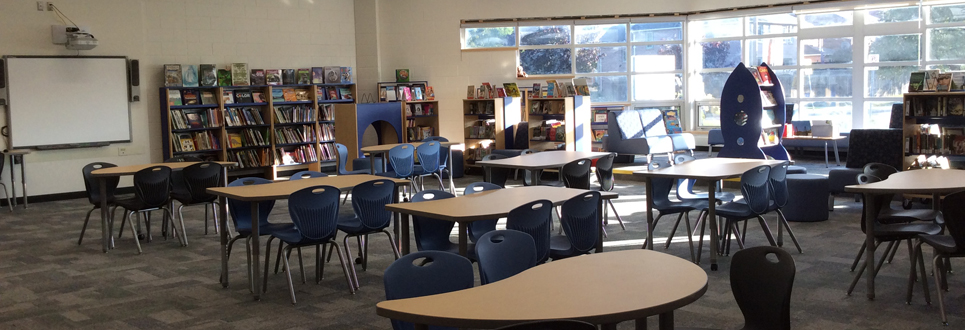 Learning Commons area of the school with books and tables